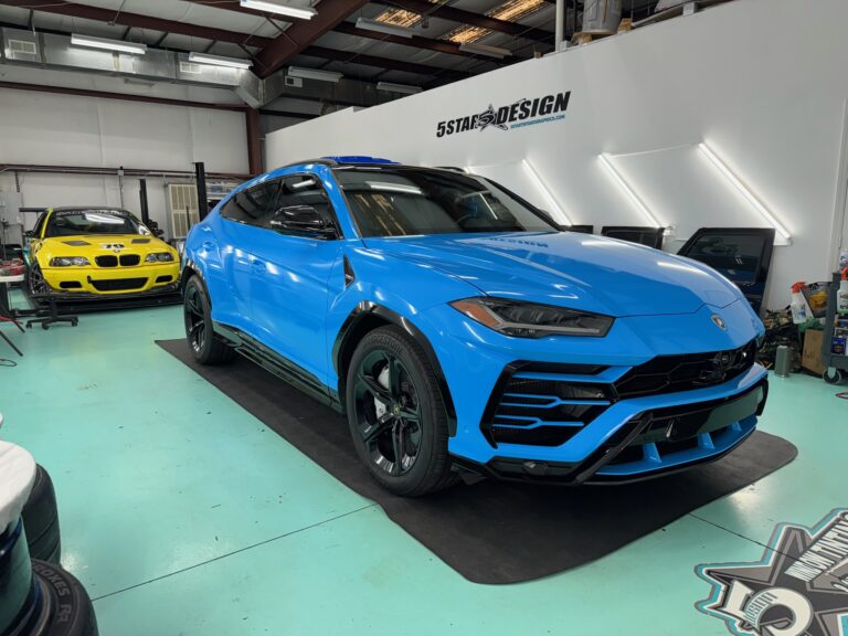 blue vinyl wrapped lamborghini suv