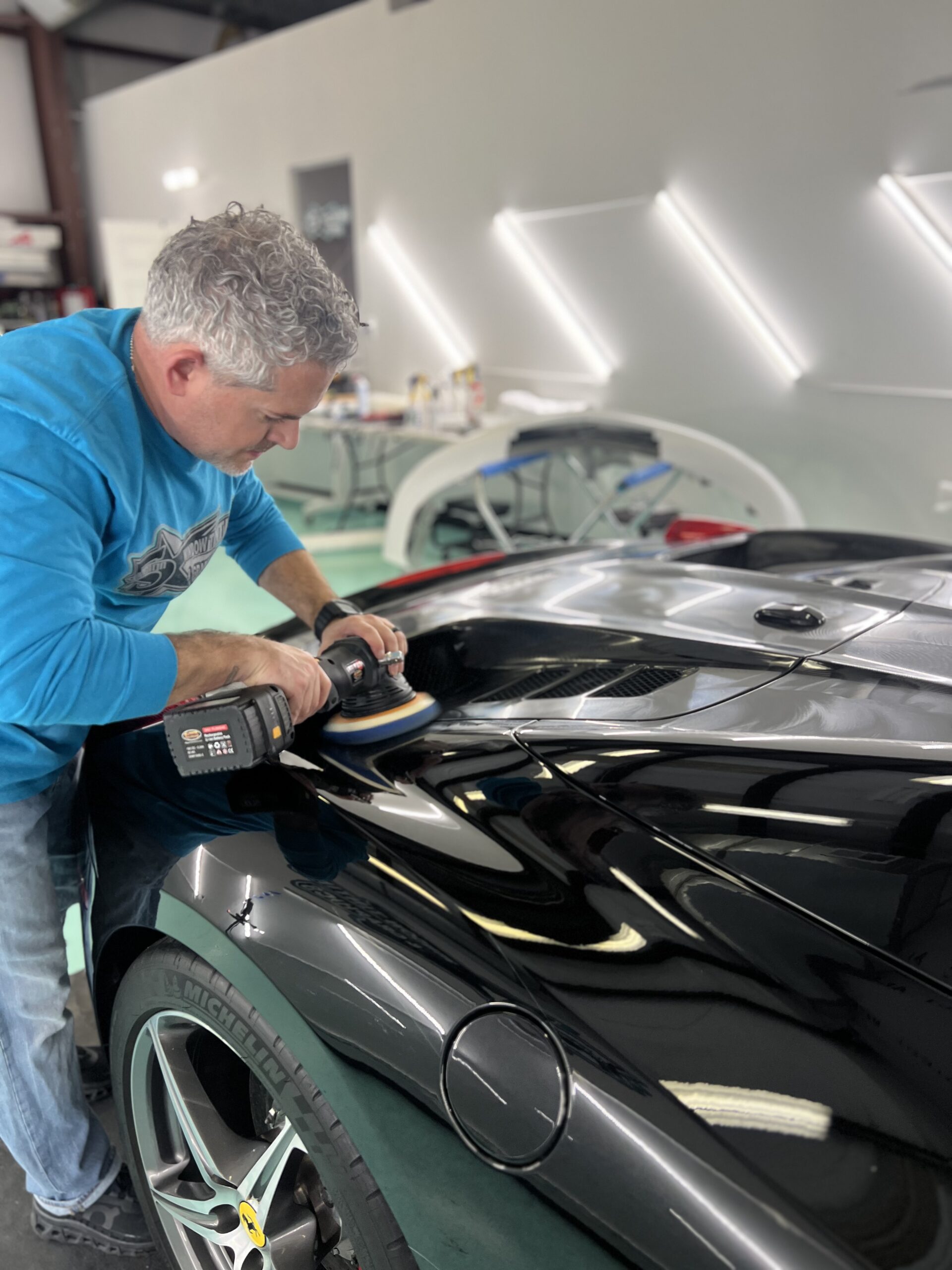 correcting the paint of an exotic car before applying ceramic coating